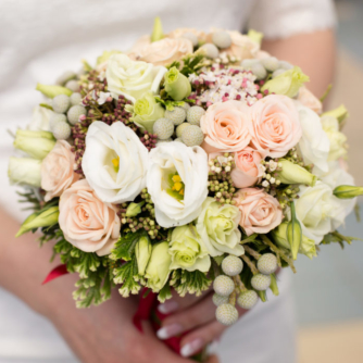 Pink bridal bouquet in bride's hands