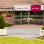 Exterior shot of Mercure Swansea Hotel, flower bed by front door