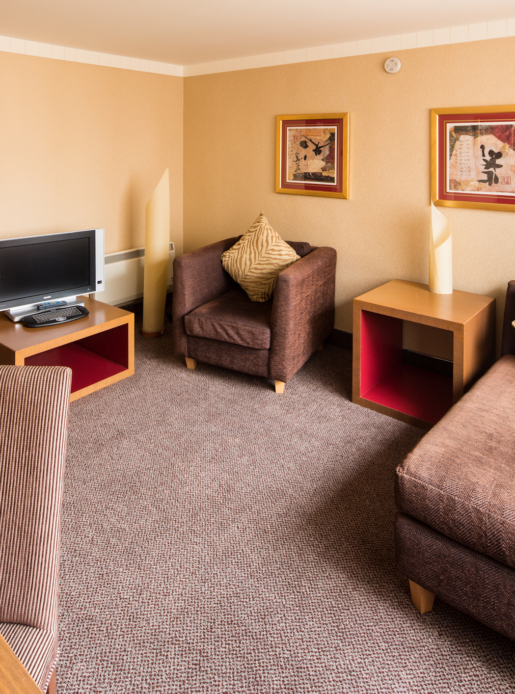 Superior room at Mercure Swansea Hotel, seating lounge area, sofa, tv, desk