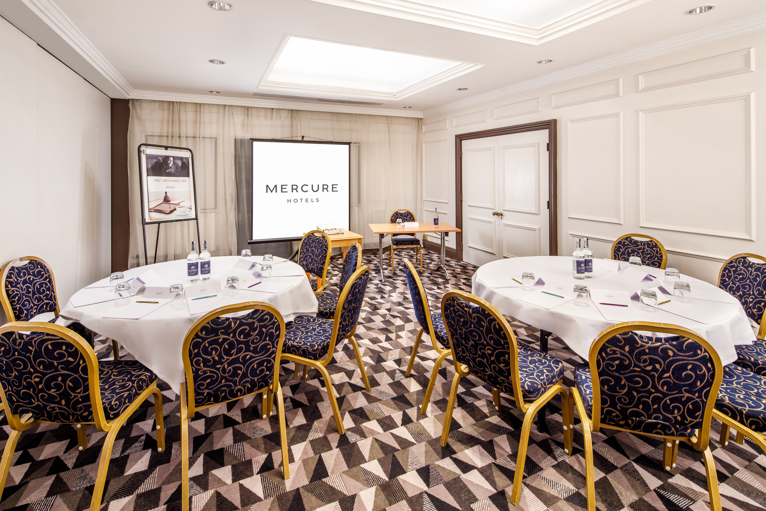 Tables set for private dining in the senate room at mercure gloucester bowden hall hotel