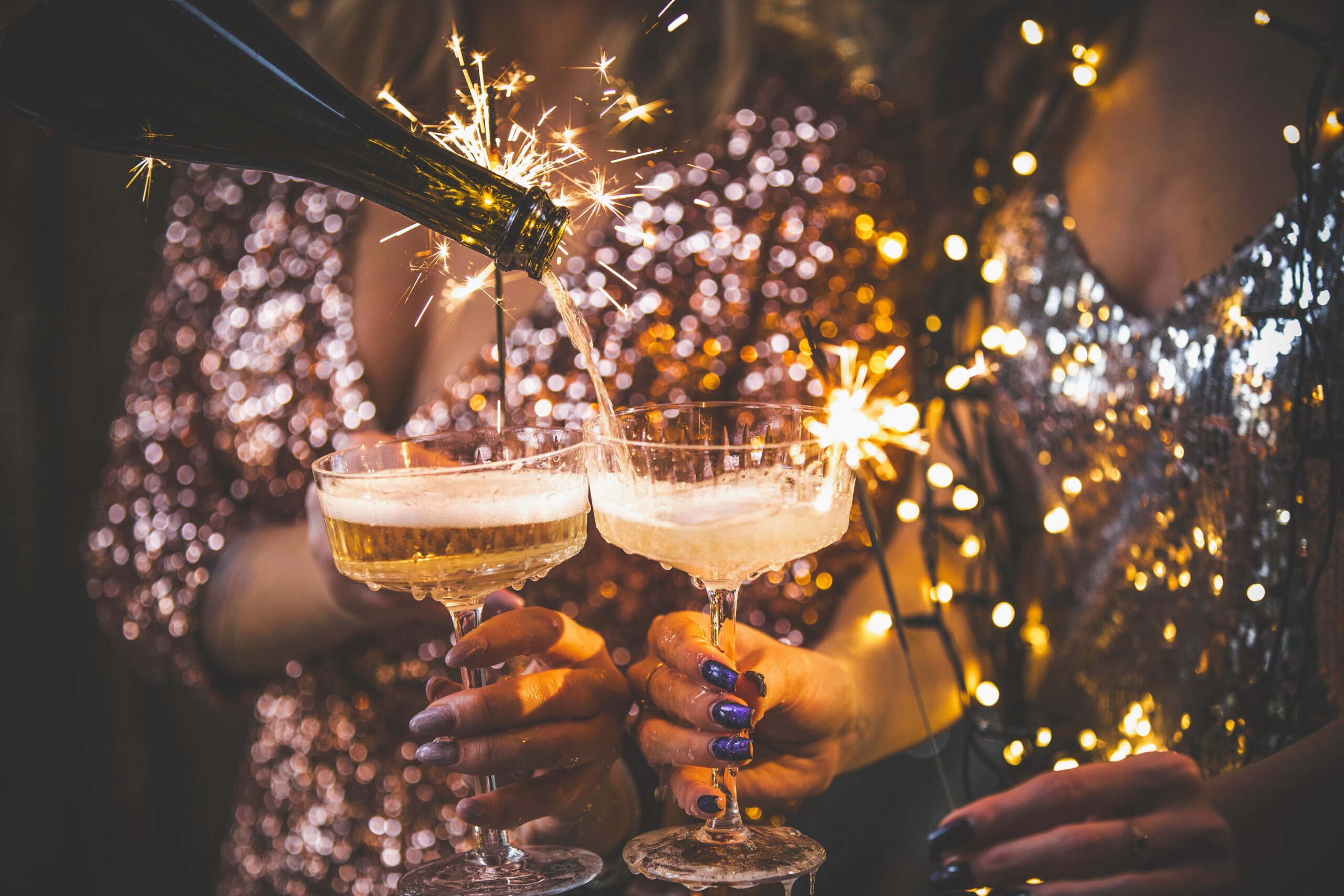 The,Girls,Pour,Champagne,Into,Round,Glasses,From,A,Bottle. Work colleges partying